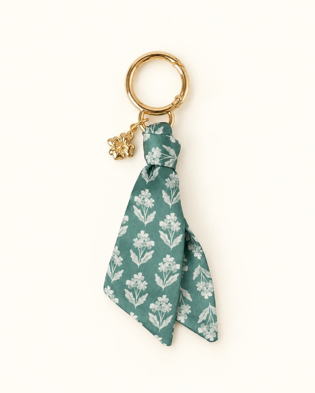 Elyse Breanne Design Forget Me Nots satin keychain with muted green and white floral fabric, gold spring gate keyring, and gold flower charm.