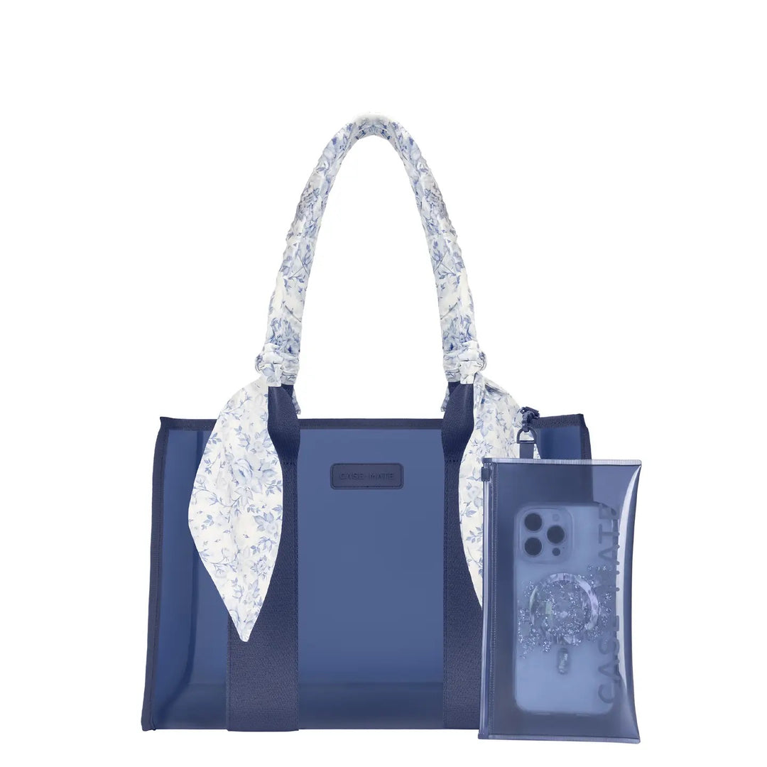 Case-Mate Something Navy Twilly Jelly Tote Bag in medium featuring a navy blue waterproof TPU body, blue and white floral scarf-wrapped handles, navy trim, and front Case-Mate logo. Includes a coordinating transparent zip pouch attached to the handle. Displayed against a clean white studio background.