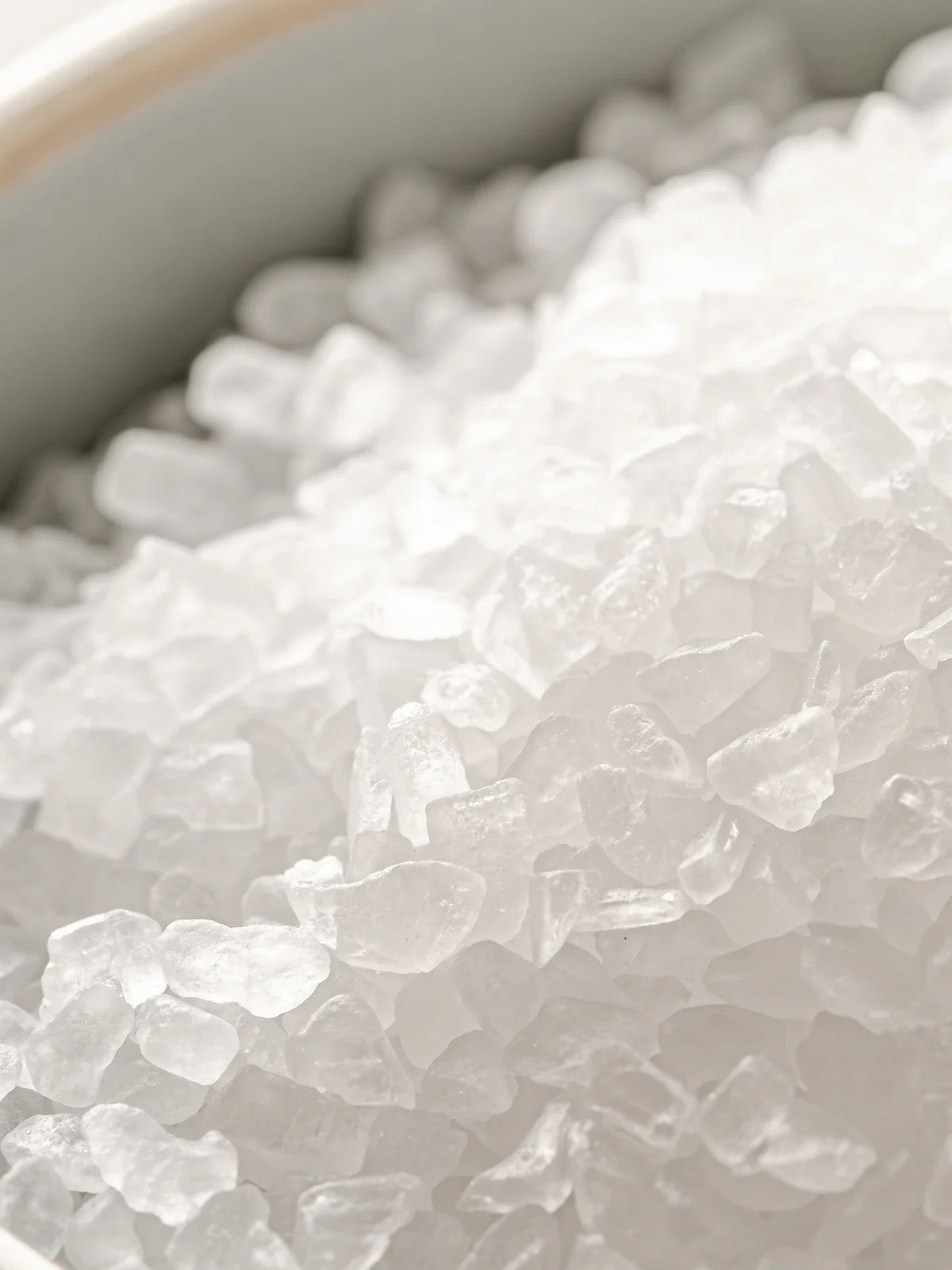 Close-up of white sea salt crystals in a bowl