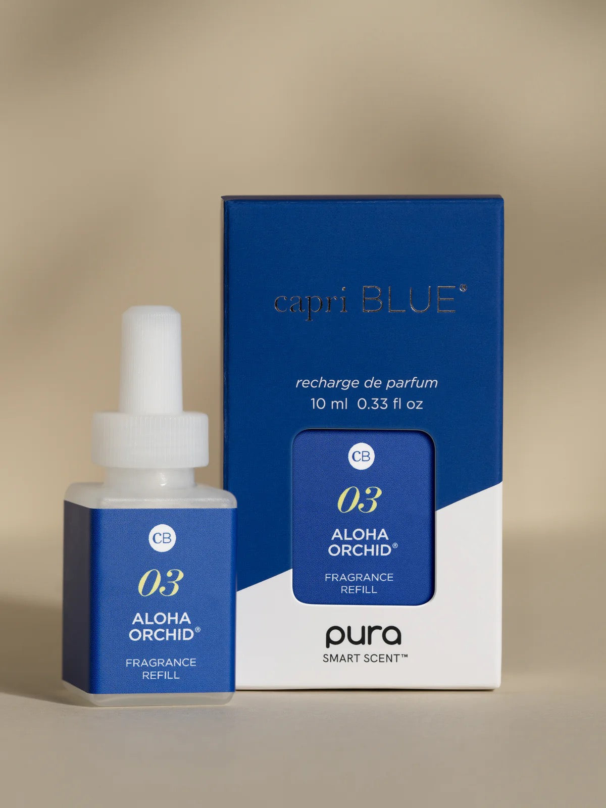 Capri Blue Aloha Orchid fragrance refill bottle and packaging on a beige background