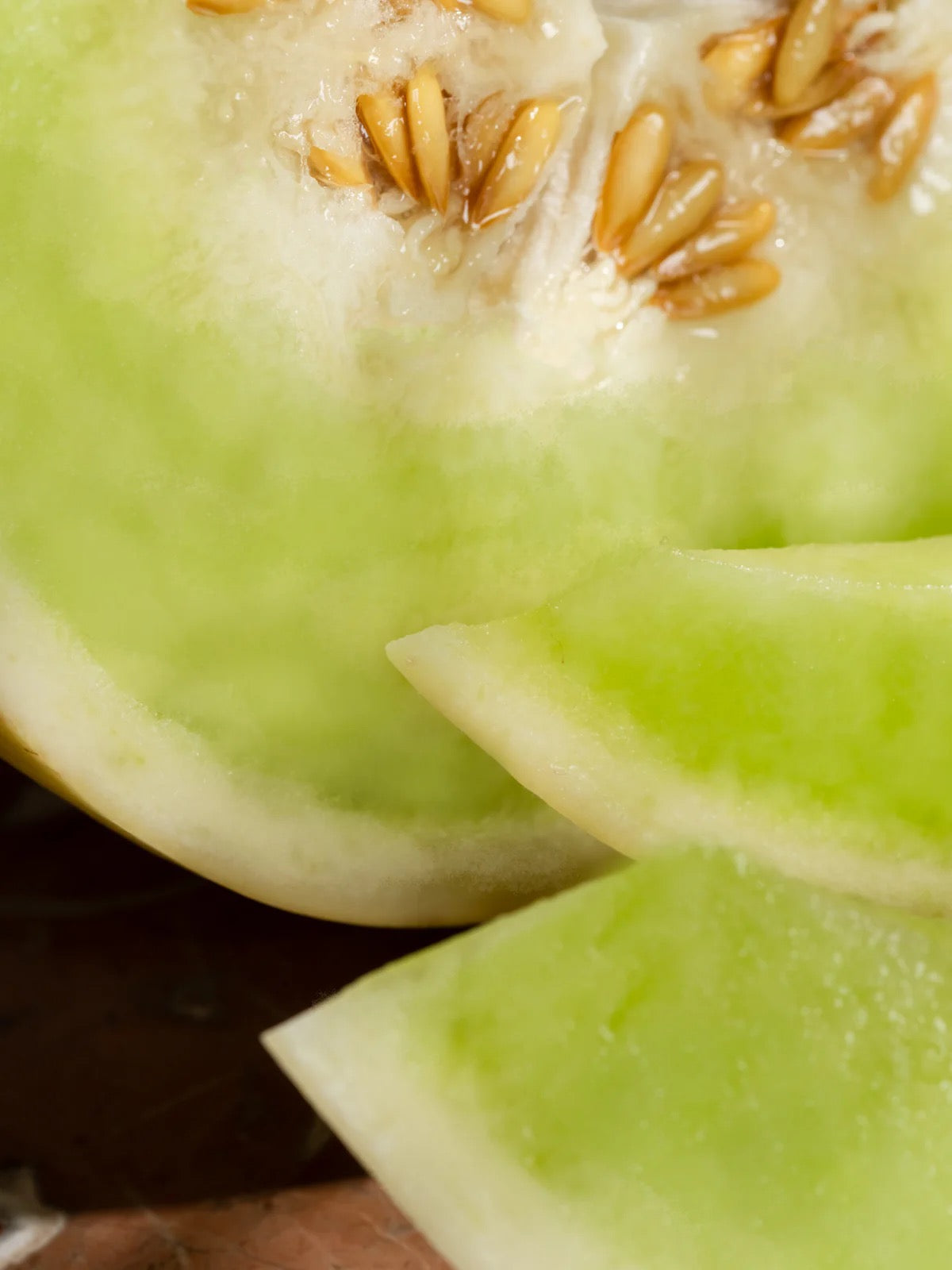 Close-up of a sliced honeydew melon with seeds.