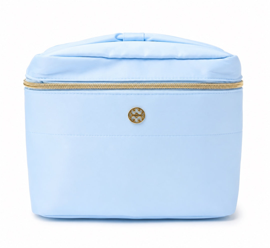 Sky blue large cosmetic travel bag with top carry handle, gold-tone zipper, structured design, and roomy storage for makeup, skincare, toiletries, and travel accessories.