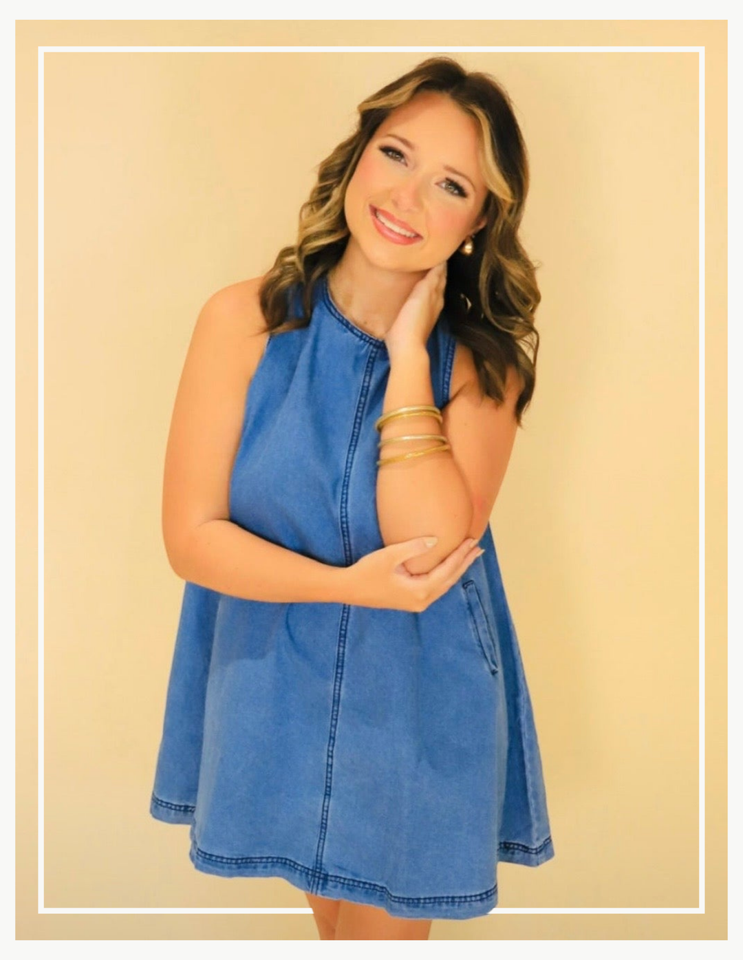 Woman wearing a blue dress against a beige background