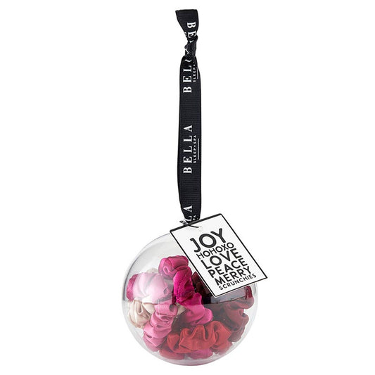 Decorative Christmas ornament with pink and red scrunchies and a black ribbon with text on a white background