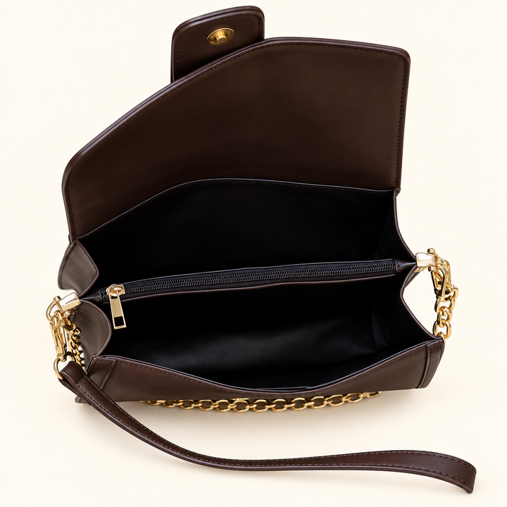 Interior view of the Chocolate Collins Crossbody showing its accordion-style organization, center zippered compartment, magnetic closure, and dark lining.