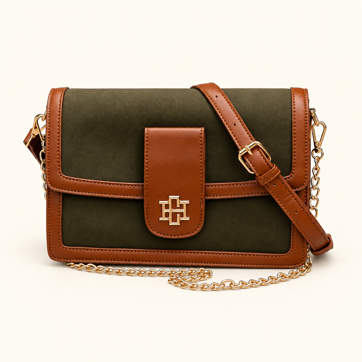 Front view of the Caroline Hill Collins Crossbody in Olive featuring brown vegan leather trim, gold logo hardware, a chain strap, and an adjustable crossbody strap.
