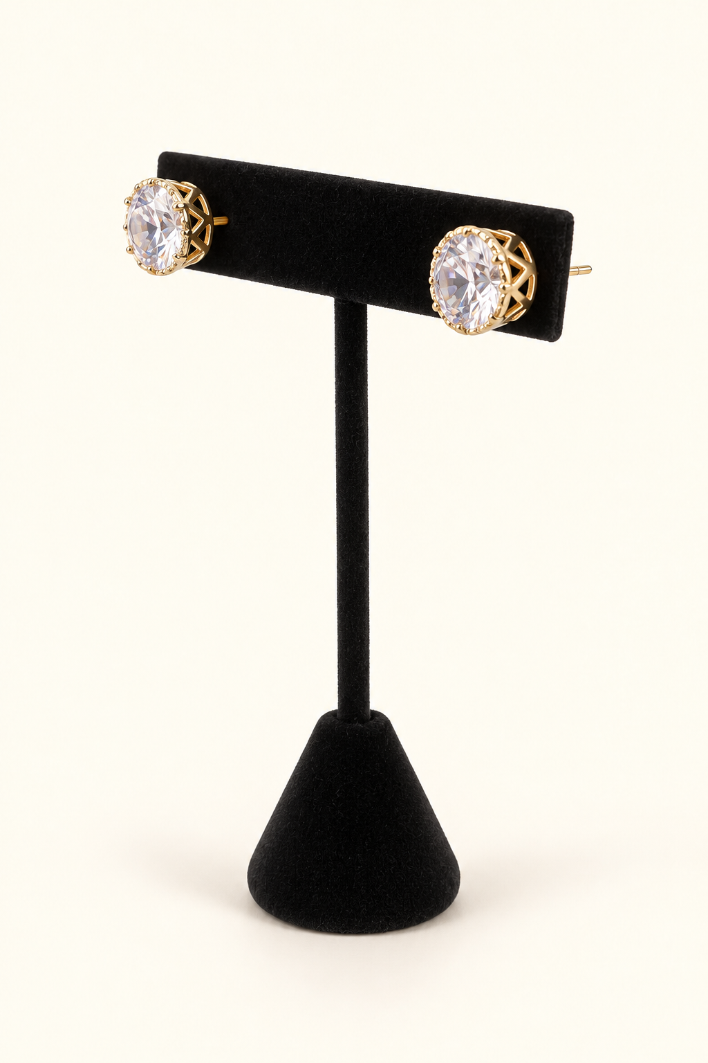 Angled view of Gilded Glow 10mm glass bead stud earrings showing the clear faceted stones and dimensional gold-tone settings.