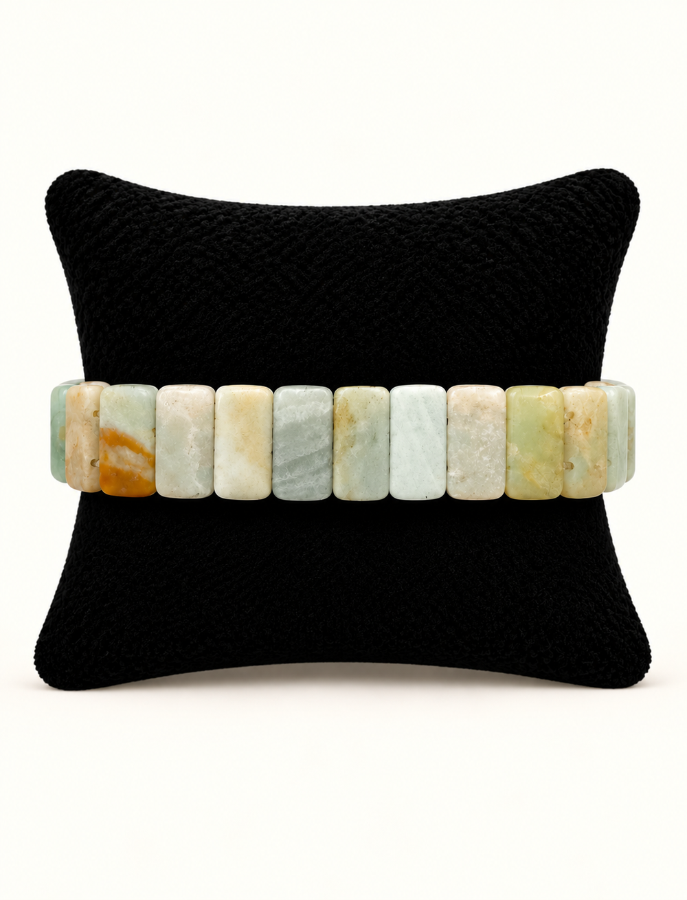 Back view of Sea Mist Healing Stone Apple Watch Band featuring rectangular pale aqua, seafoam, cream and neutral stone beads on a black display pillow.