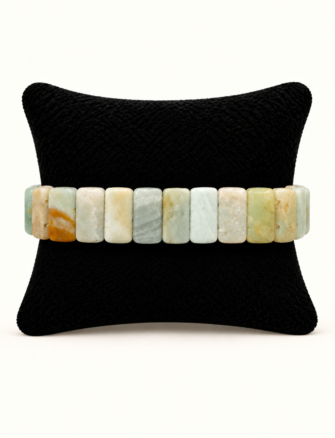 Back view of Sea Mist Healing Stone Apple Watch Band featuring rectangular pale aqua, seafoam, cream and neutral stone beads on a black display pillow.