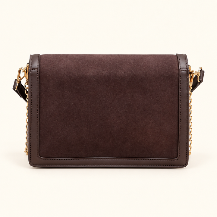Back view of the Caroline Hill Collins Crossbody in Chocolate featuring a smooth suede-feel panel, vegan leather trim, and gold-tone strap hardware.