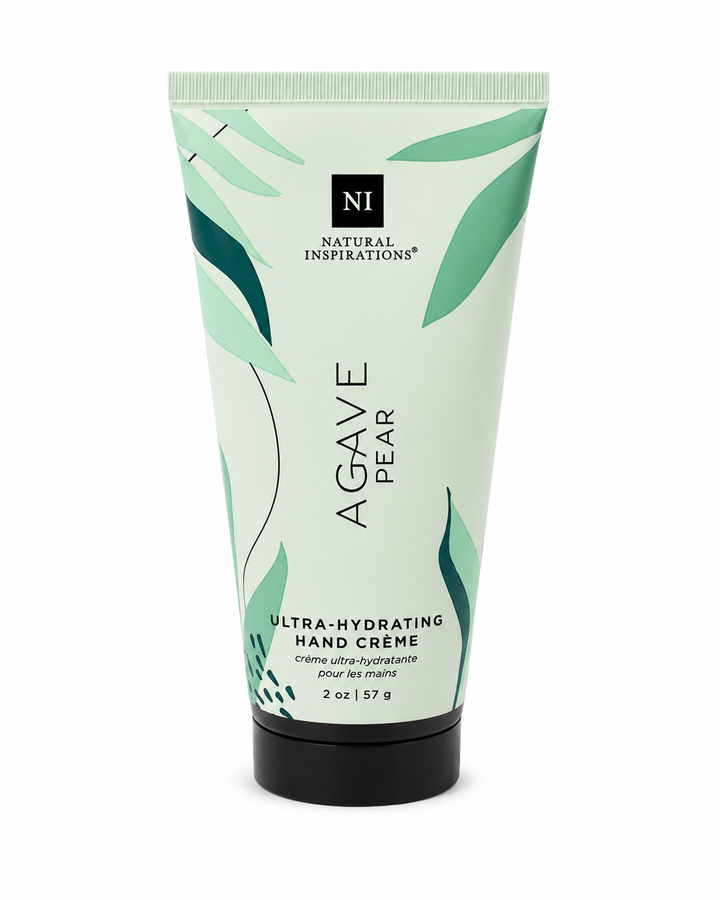 Natural Inspirations Agave Pear Ultra-Hydrating Hand Crème (2 oz / 57 g) in a pale mint green squeeze tube with teal leaf accents and a black flip-top cap, photographed on a white studio background.