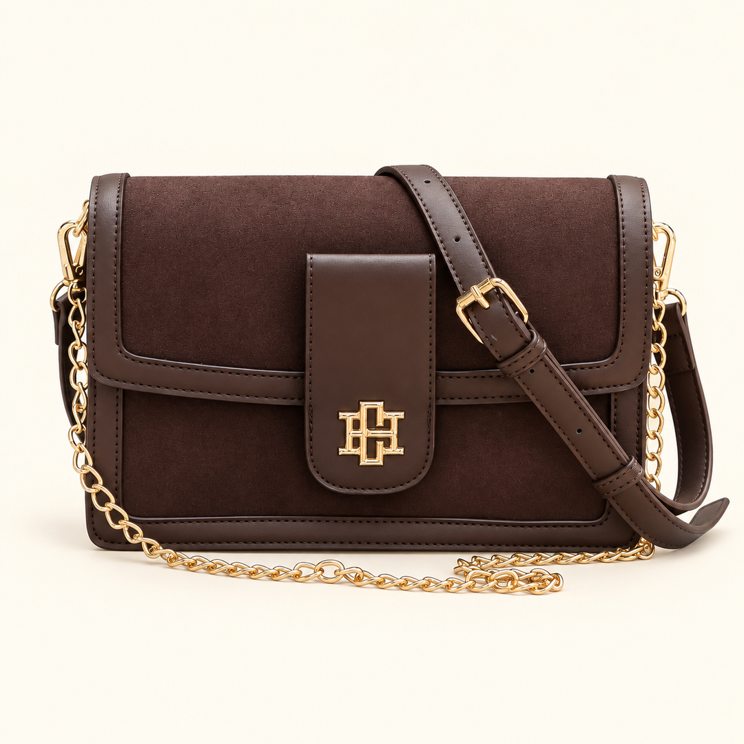 Front view of the Caroline Hill Collins Crossbody in Chocolate featuring suede-feel panels, vegan leather trim, gold hardware, and two removable straps.