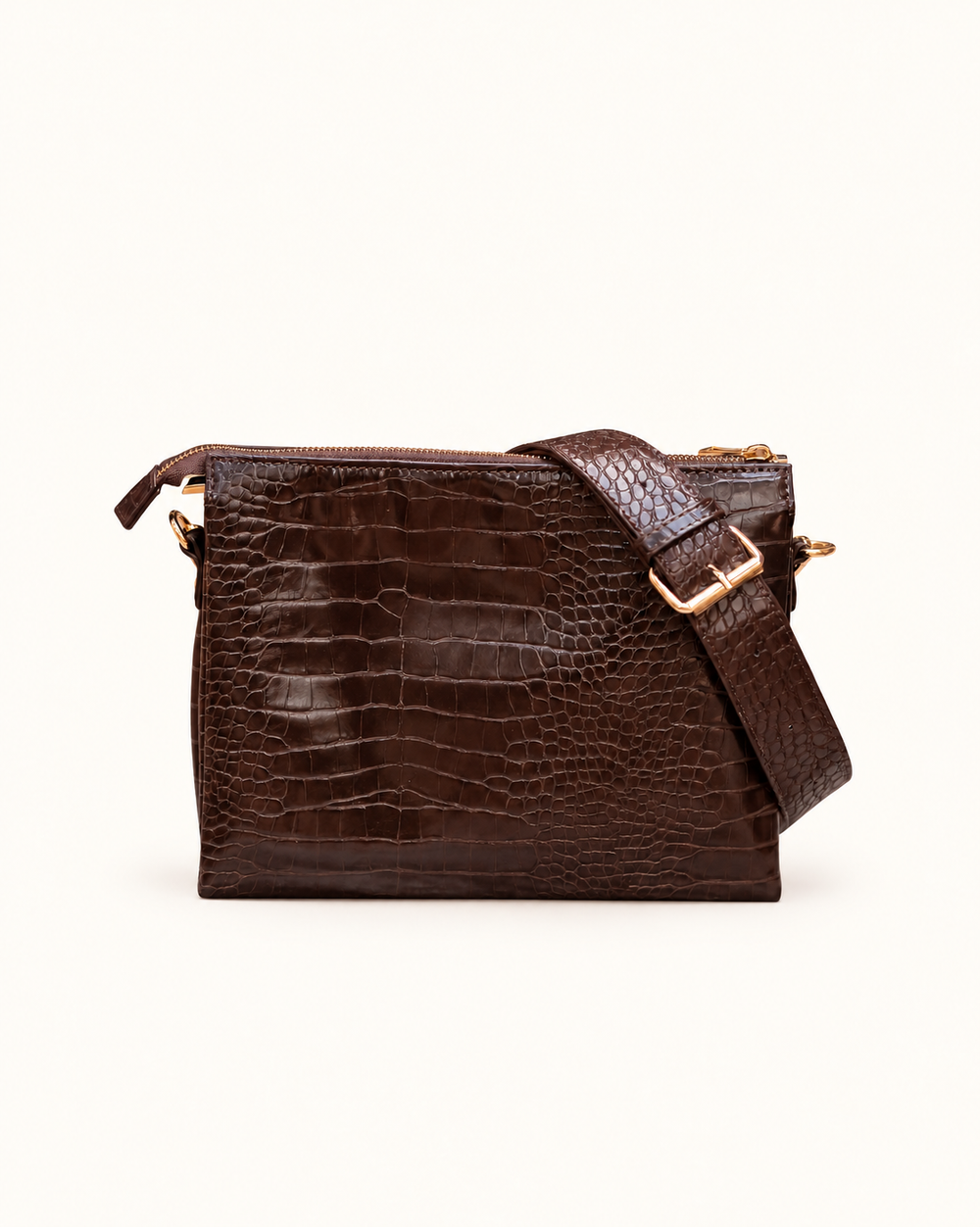 Back view of the Caroline Hill Ariana chocolate croc-embossed crossbody bag with an adjustable strap and gold hardware.