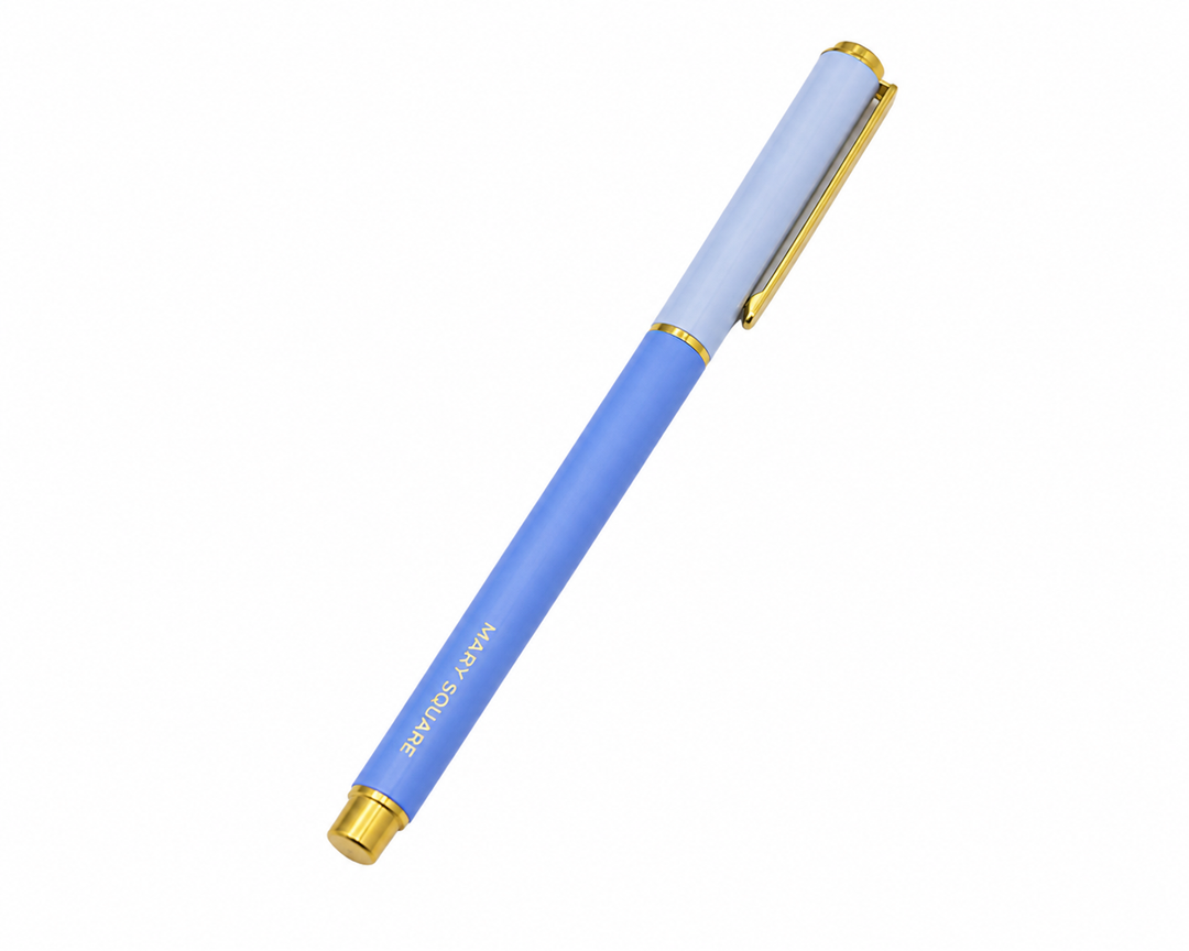 Blue and light blue Snap Cap Colorblock Pen by Mary Square with gold trim on a white studio background.