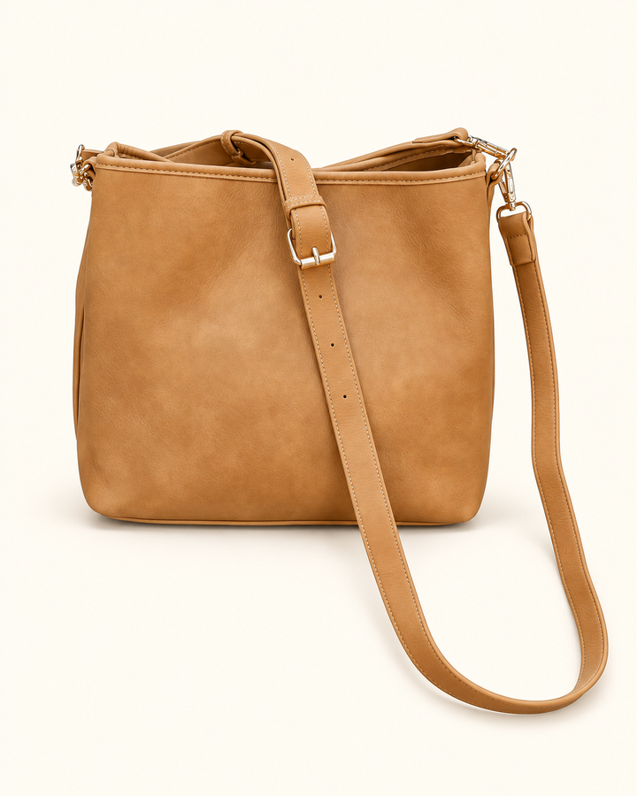Back view of the mustard Caroline Hill Alexandra Bucket Bag with gold hardware and an adjustable long strap.