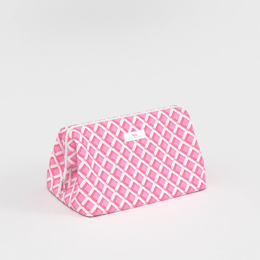 Side view of Big Mouth Makeup Bag in Garden Gate pink lattice print, wide-base cosmetic bag with zip-top closure.