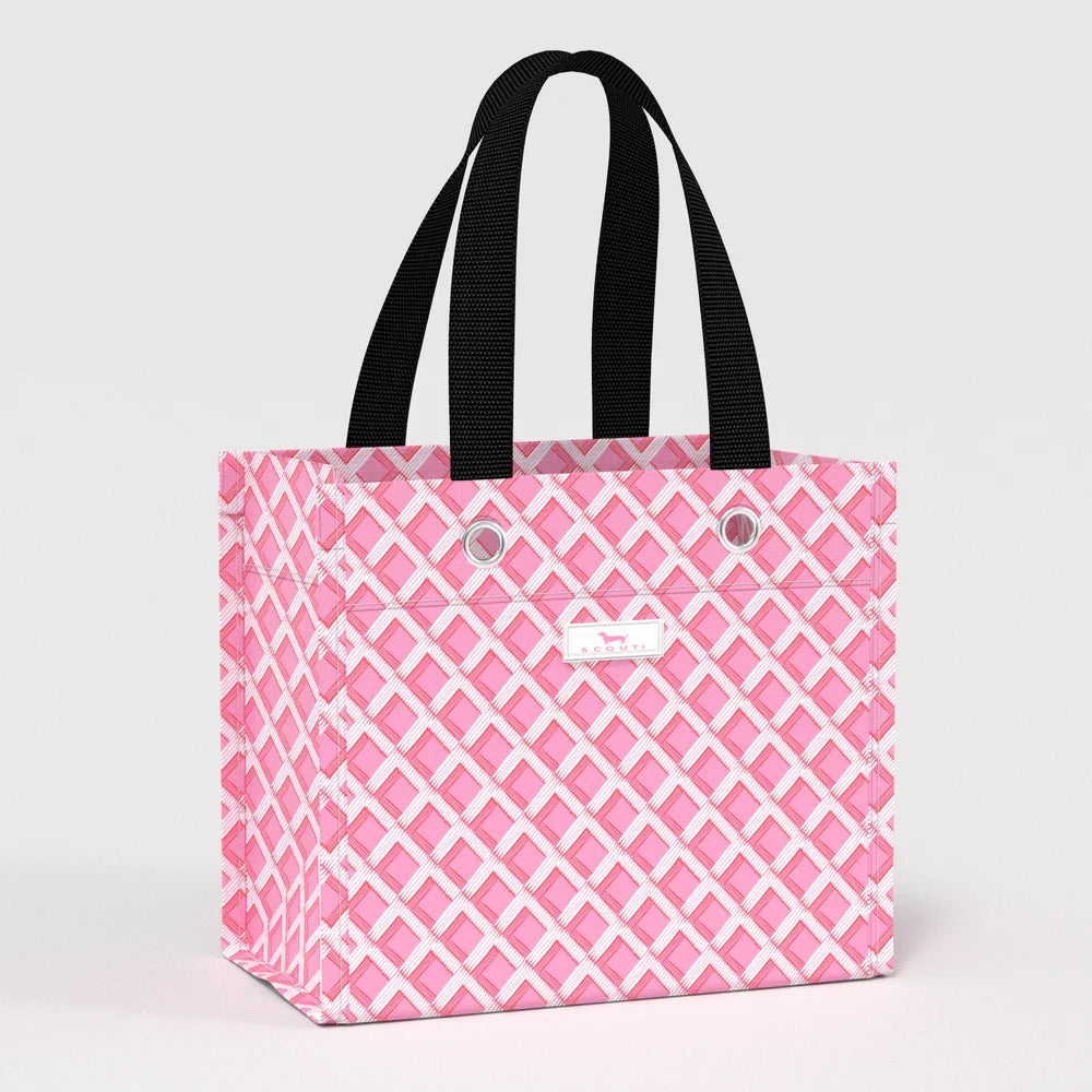 Angled view of Gift Bag Small in Garden Gate pink lattice pattern, structured reusable gift bag with black carry handles.