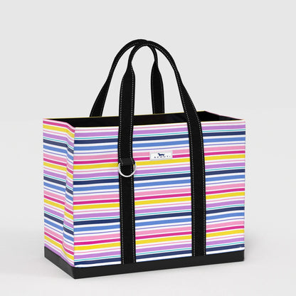 Side view of Original Deano Tote Large Bag in Stripe a Pose multicolor stripe print, oversized market tote with sturdy construction and black straps.