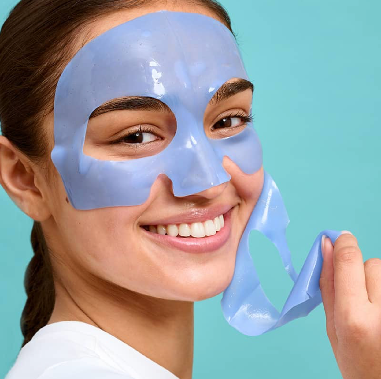 Woman wearing a blue face mask against a light blue background