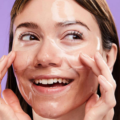 Woman applying a skincare product on her face with a purple background