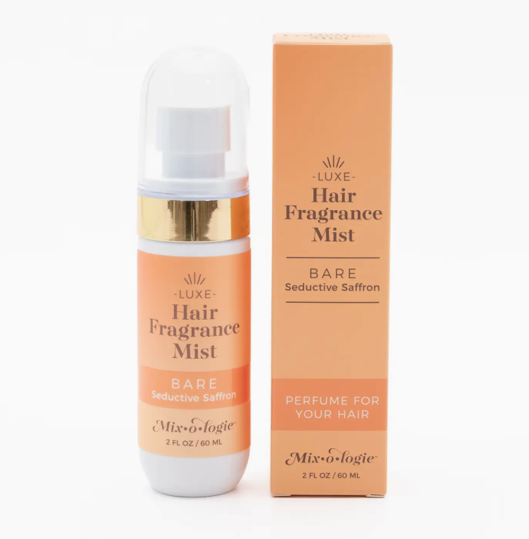 Mixologie Bare Hair Fragrance Mist (60 mL) featuring the Seductive Saffron scent. Alcohol-free hair perfume in a peach bottle with a white cap and gold accent displayed beside its matching peach box on a white background. Designed to add shine, tame frizz, and leave hair with a long-lasting luxurious fragrance.