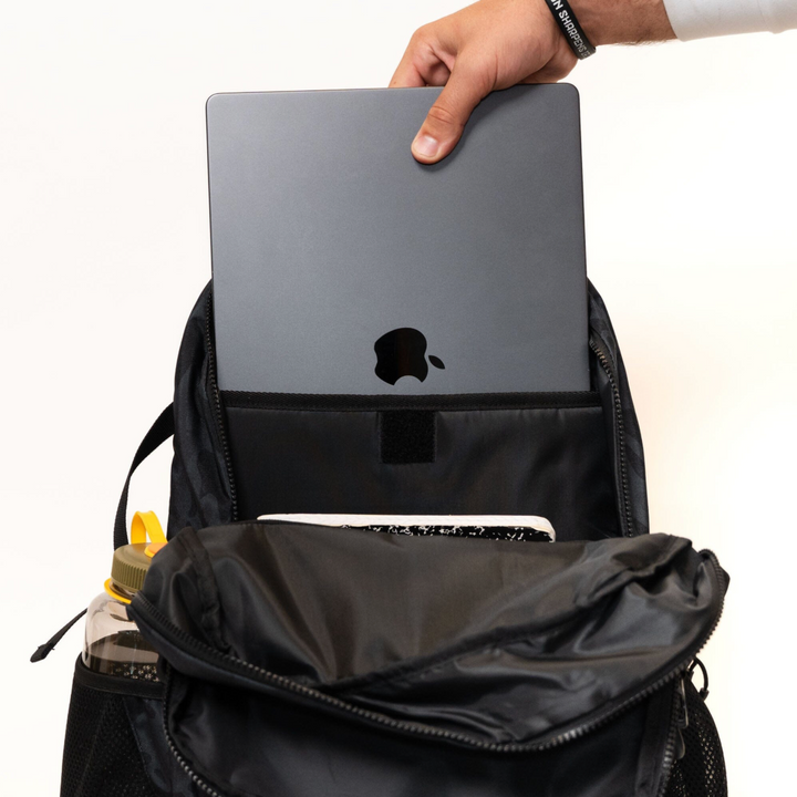 Open Burlebo Black Camo backpack displaying the padded laptop sleeve designed to securely hold a laptop or tablet.