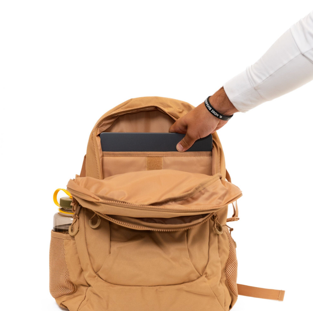 Open Burlebo Coyote Tan backpack displaying the spacious main compartment with a padded laptop sleeve and organized interior storage.