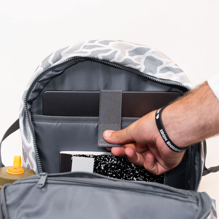 Burlebo White Camo backpack featuring the organized interior with padded laptop sleeve and storage compartments for school, work, or travel essentials.