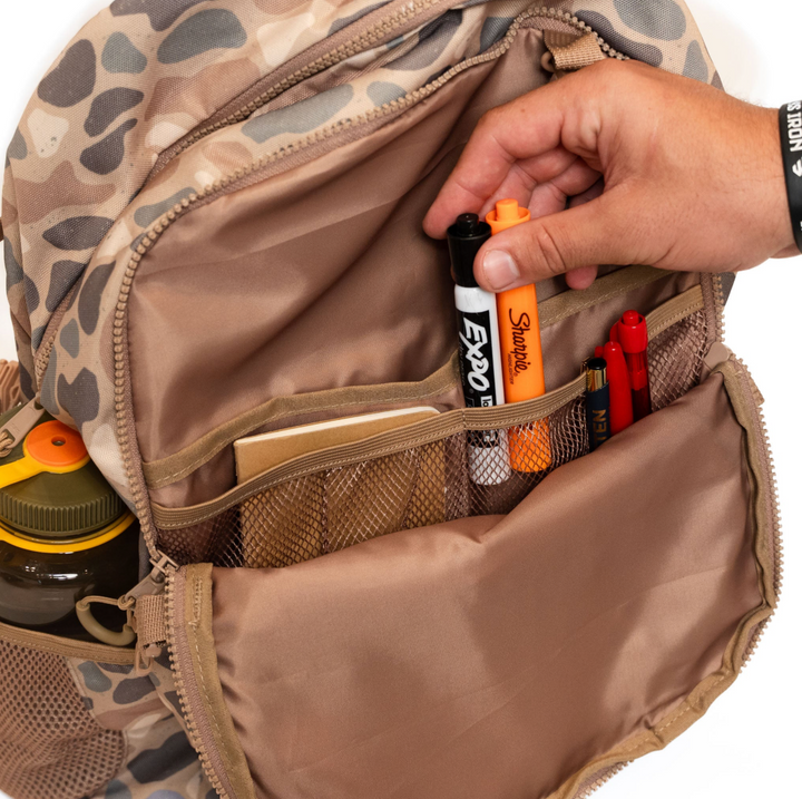 Inside the Burlebo Pintail Camo backpack showing multiple storage compartments, accessory pockets, and organized interior layout.