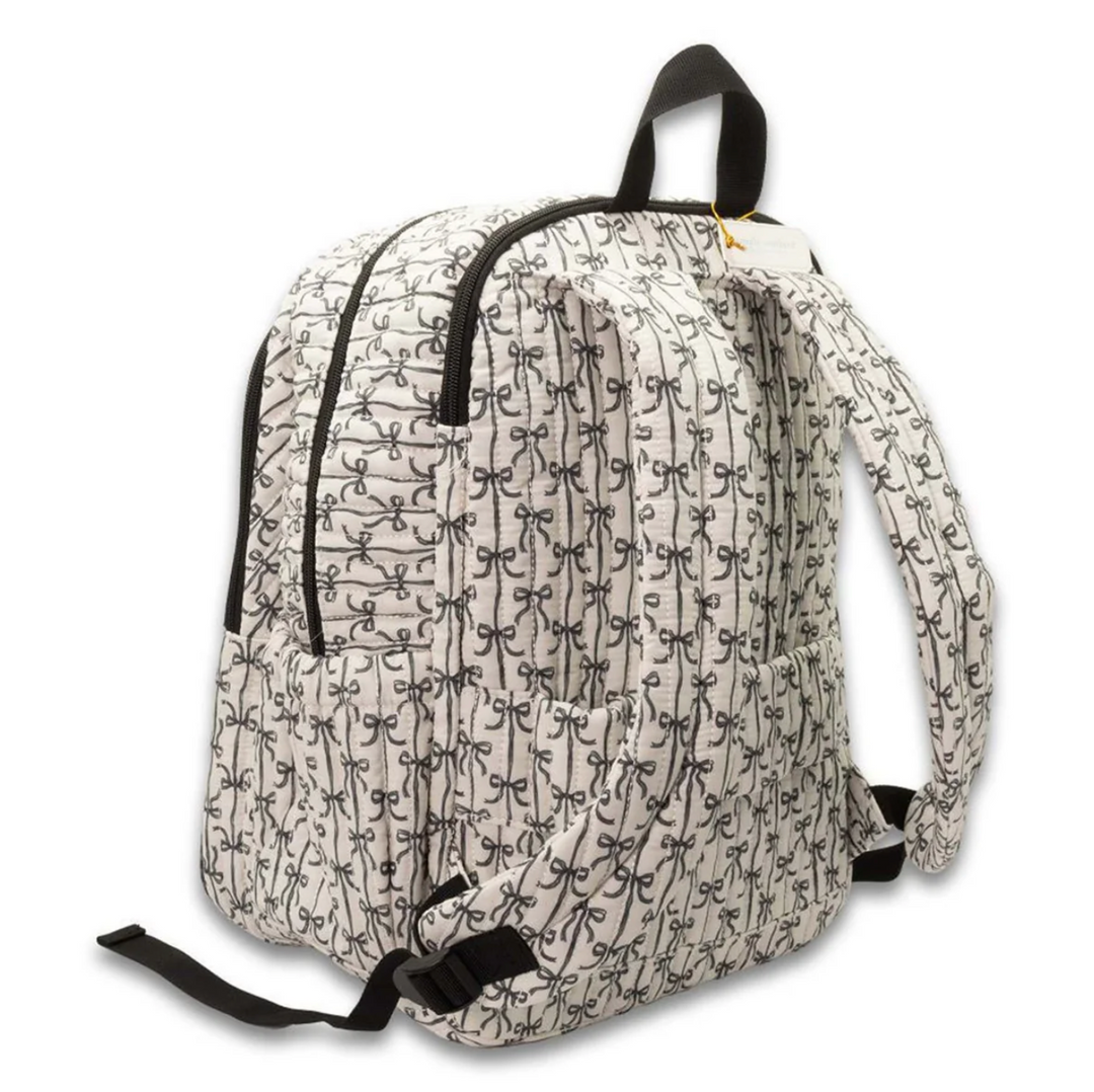 Back view of the Simply Southern black bow quilted backpack showing padded adjustable shoulder straps, quilted bow print, top carry handle, and side storage pockets on a white background.