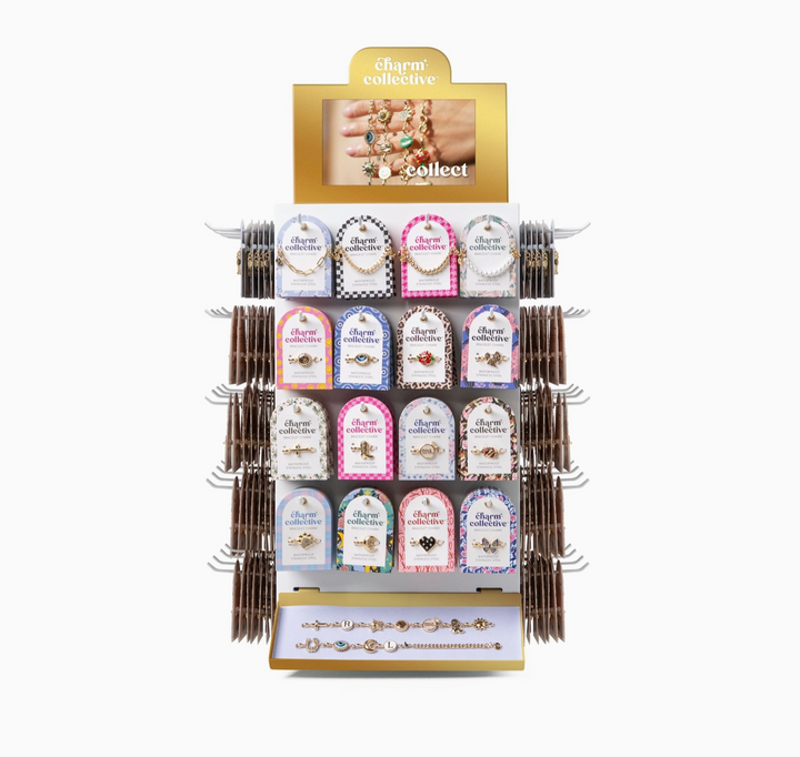 A jewelry display rack from Charm Collective, featuring multiple small arched cards with jewelry pieces and gold-tone lettering, set against a plain white background.