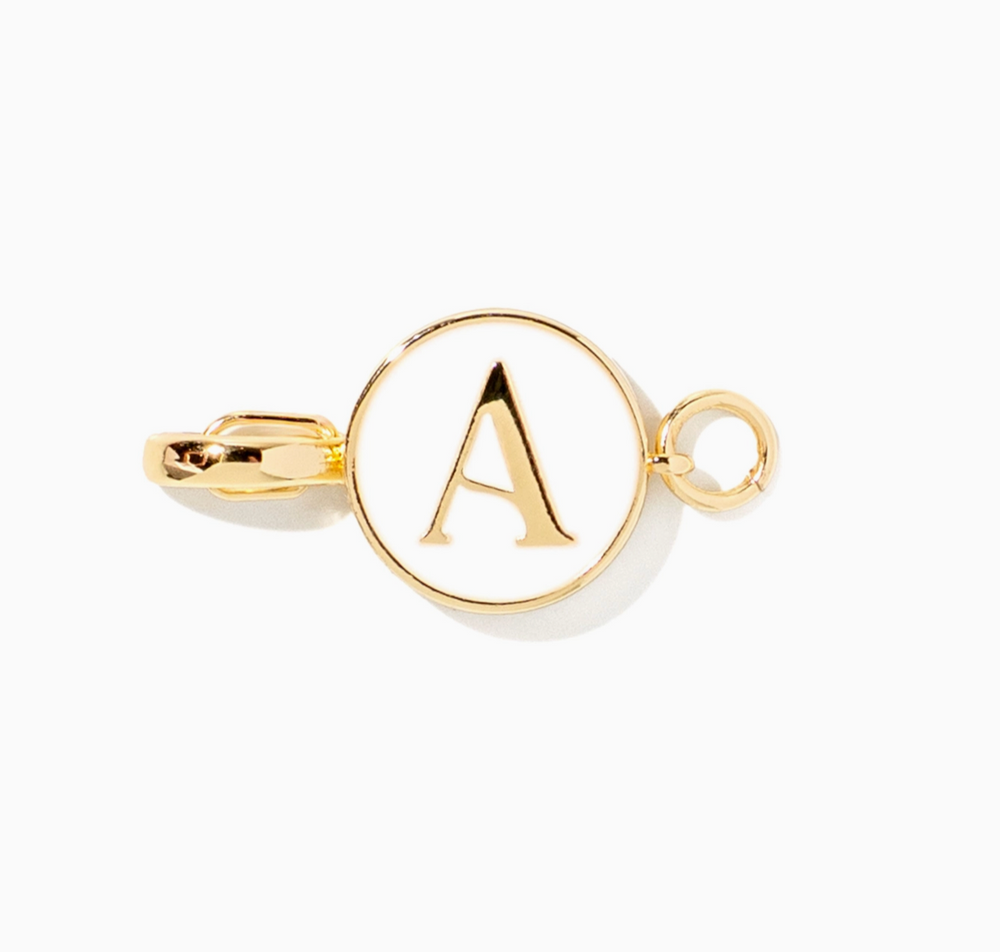 A gold-toned metal tie bar featuring a circular pendant with a raised letter 'A' in the center and a small hanging loop on the right, shown on a plain white background.