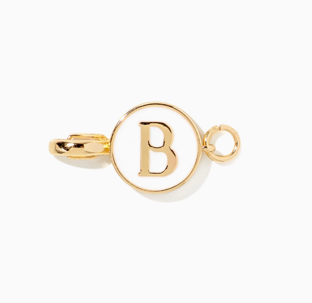 A gold-toned initial pendant charm featuring the letter 'B' inside a circular frame, with a small hanging loop on the right side, shown on a plain white background.