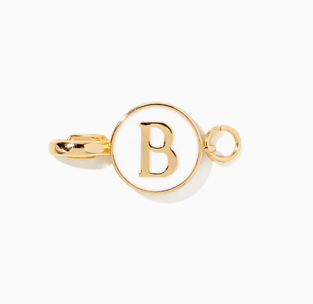 A gold-toned initial pendant charm featuring the letter &