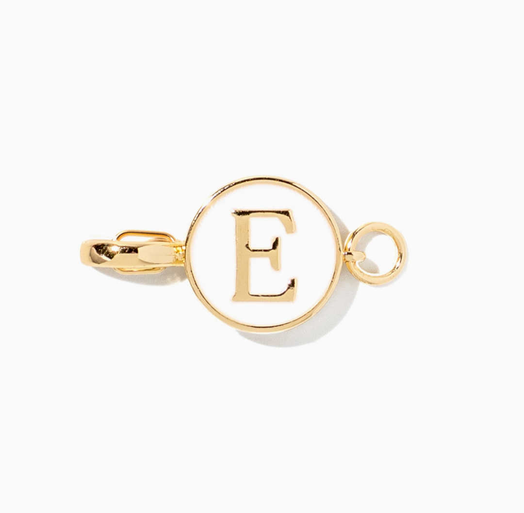 A gold initial pendant charm featuring the letter &