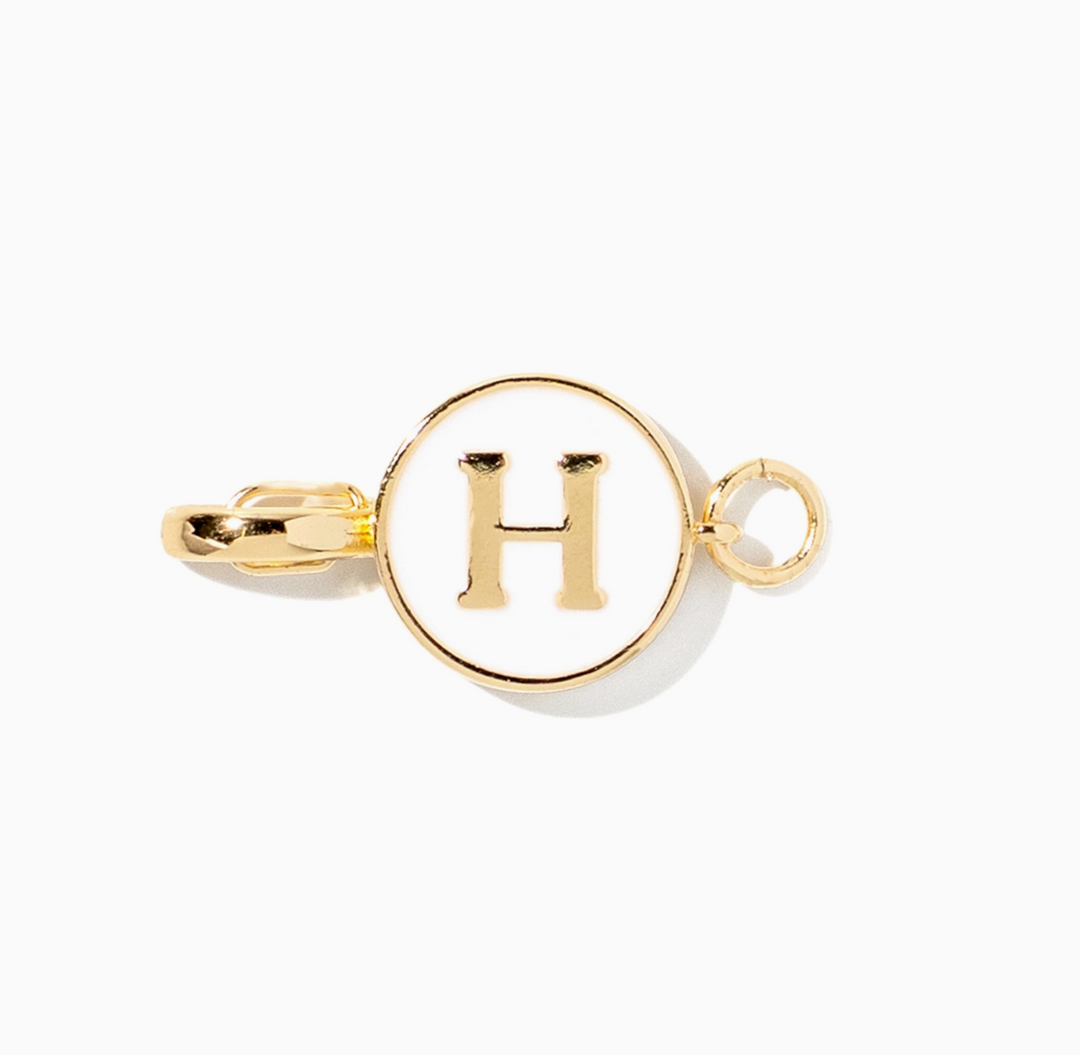 A gold initial pendant charm featuring the letter &