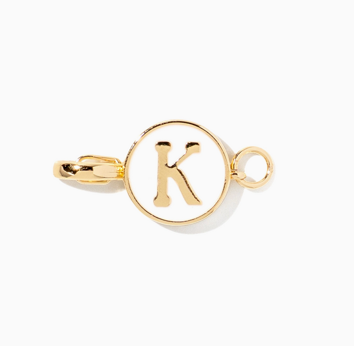 A gold initial charm link featuring a circular face with a raised letter &