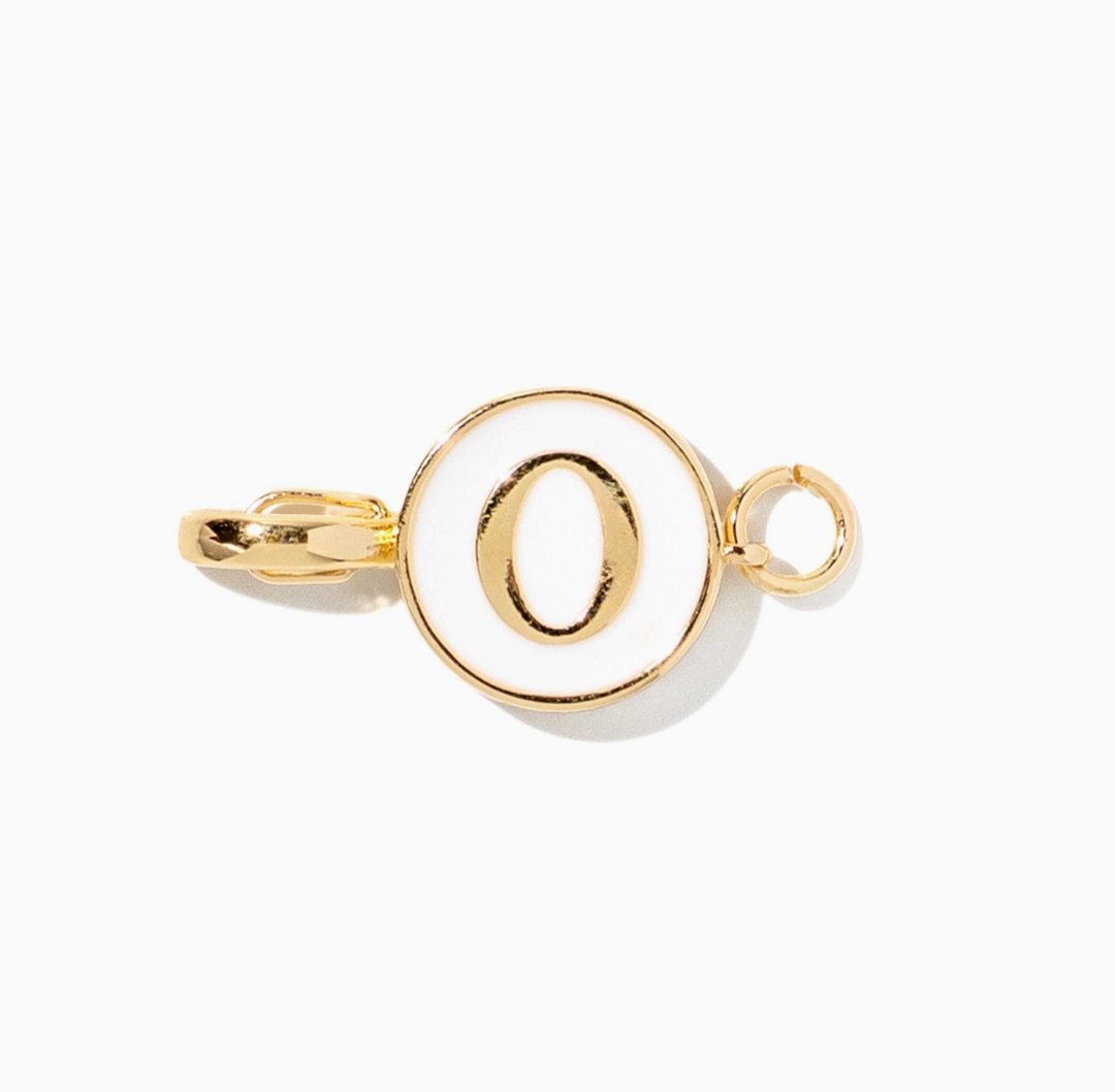A gold initial charm spelling &