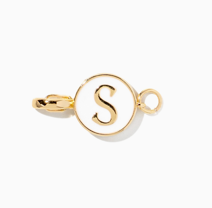 A gold initial charm featuring the letter &