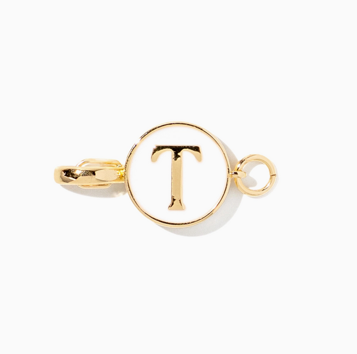 A gold-tone initial charm featuring the letter &