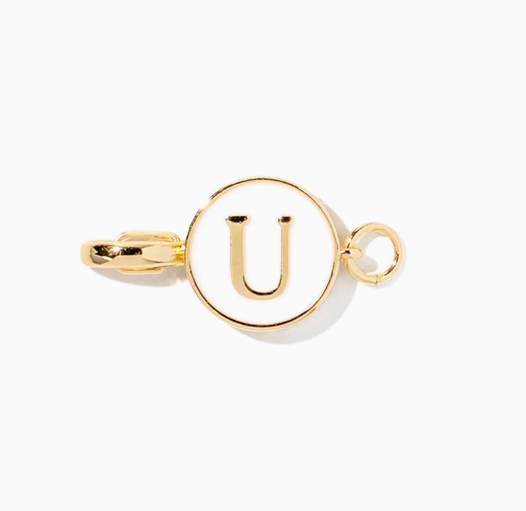 A gold initial pendant charm featuring the letter &