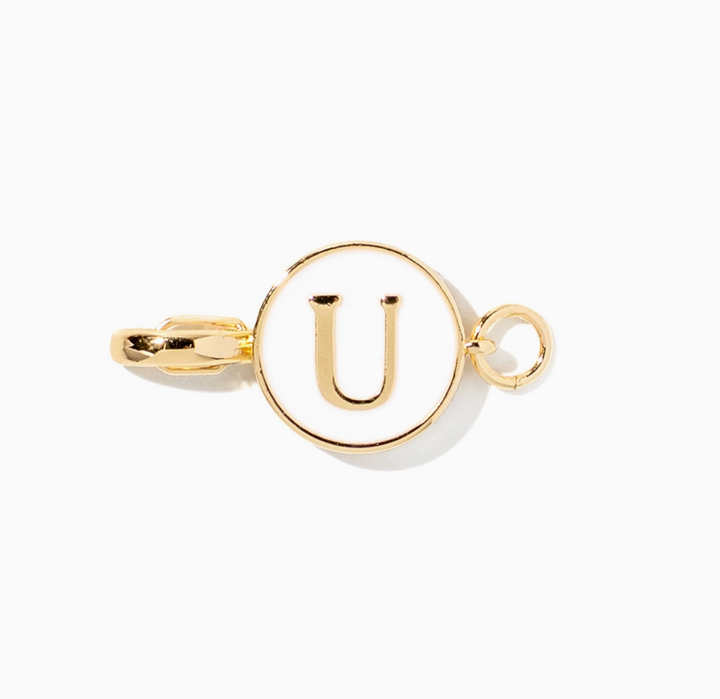 A gold initial pendant charm featuring the letter &