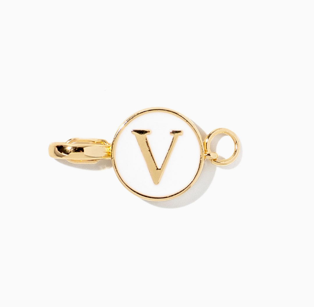 A gold-tone initial pendant charm featuring the letter &