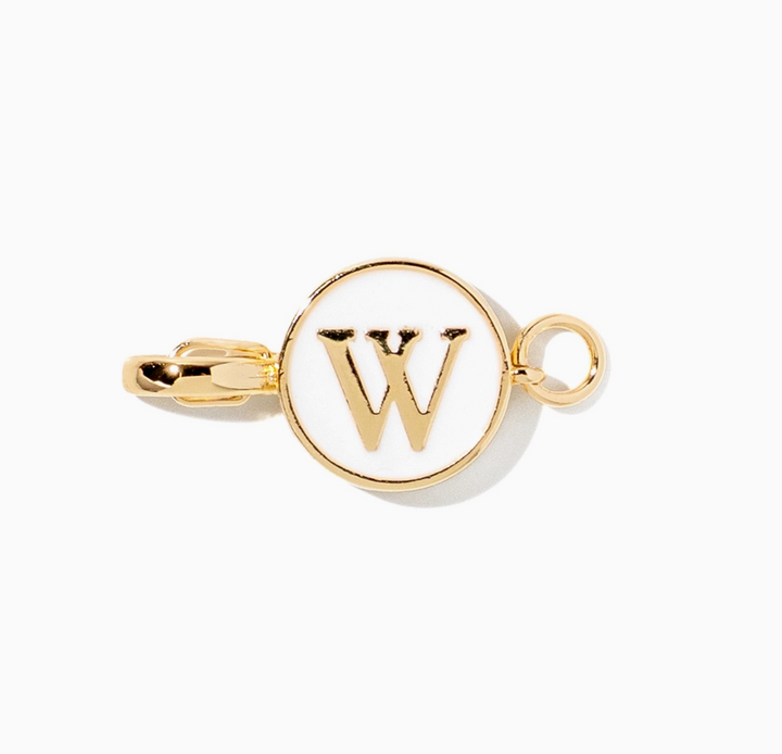 A gold initial charm featuring the letter &
