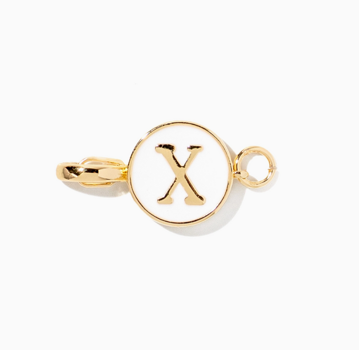 A gold initial charm featuring the letter &