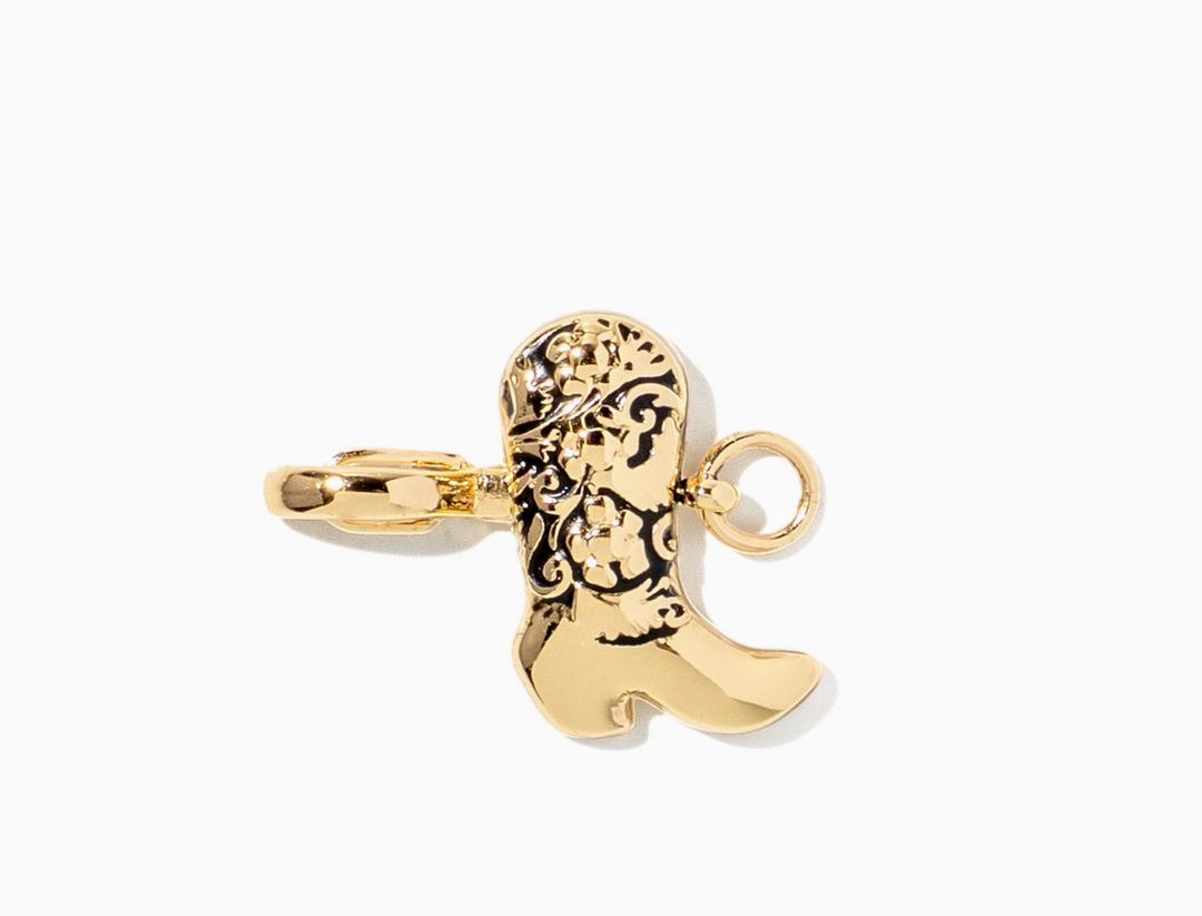 A gold-toned cowboy boot charm pendant with black oxidized detailing, shown on a clean white background.