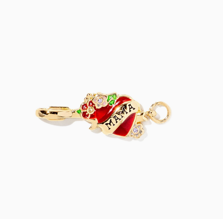 A gold-plated heart-shaped charm with red enamel, small colorful floral accents, and the word &
