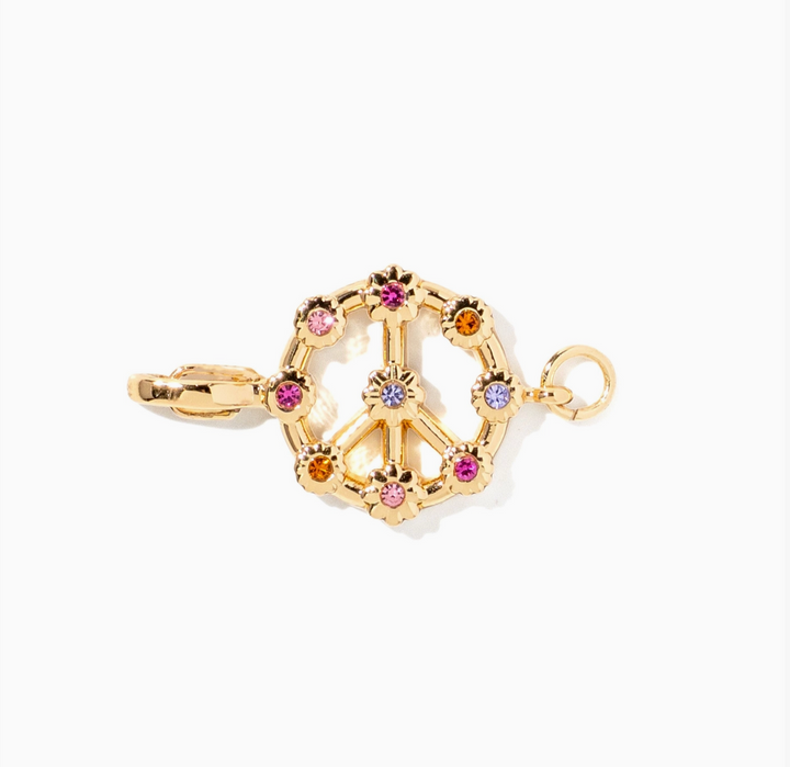 A gold charm shaped like a peace sign surrounded by a circle of small multicolored gemstones, shown on a plain white background.