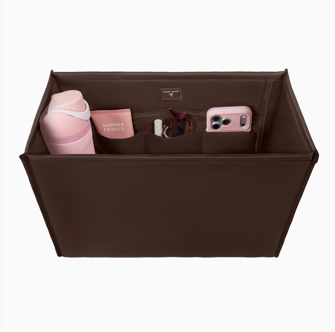 Case-Mate brown tote organizer insert with zippered compartment and multiple interior pockets holding a water bottle, cosmetics, sunglasses, and smartphone