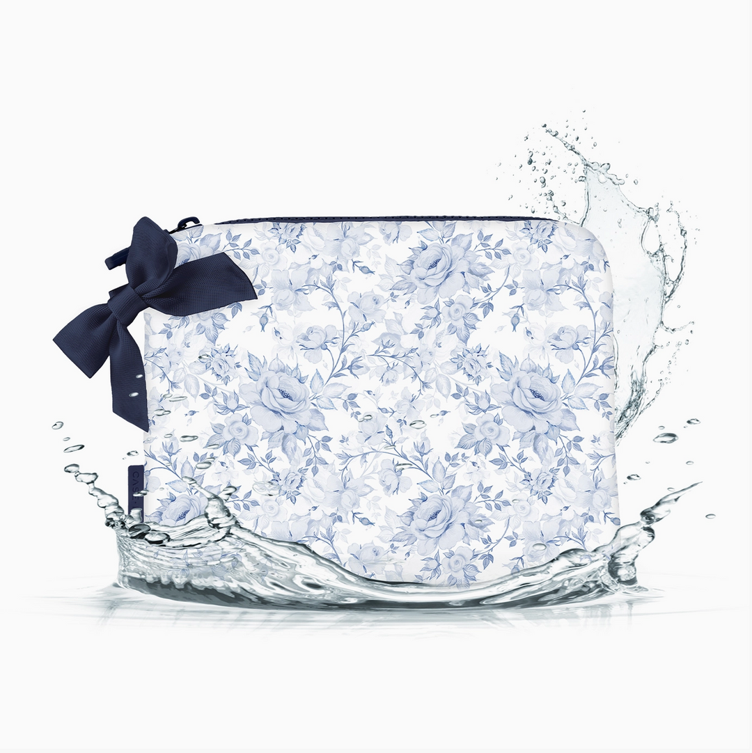 Case-Mate blue floral crinkle makeup bag featuring a delicate blue rose print, navy zipper trim, and decorative navy bow with water-resistant design